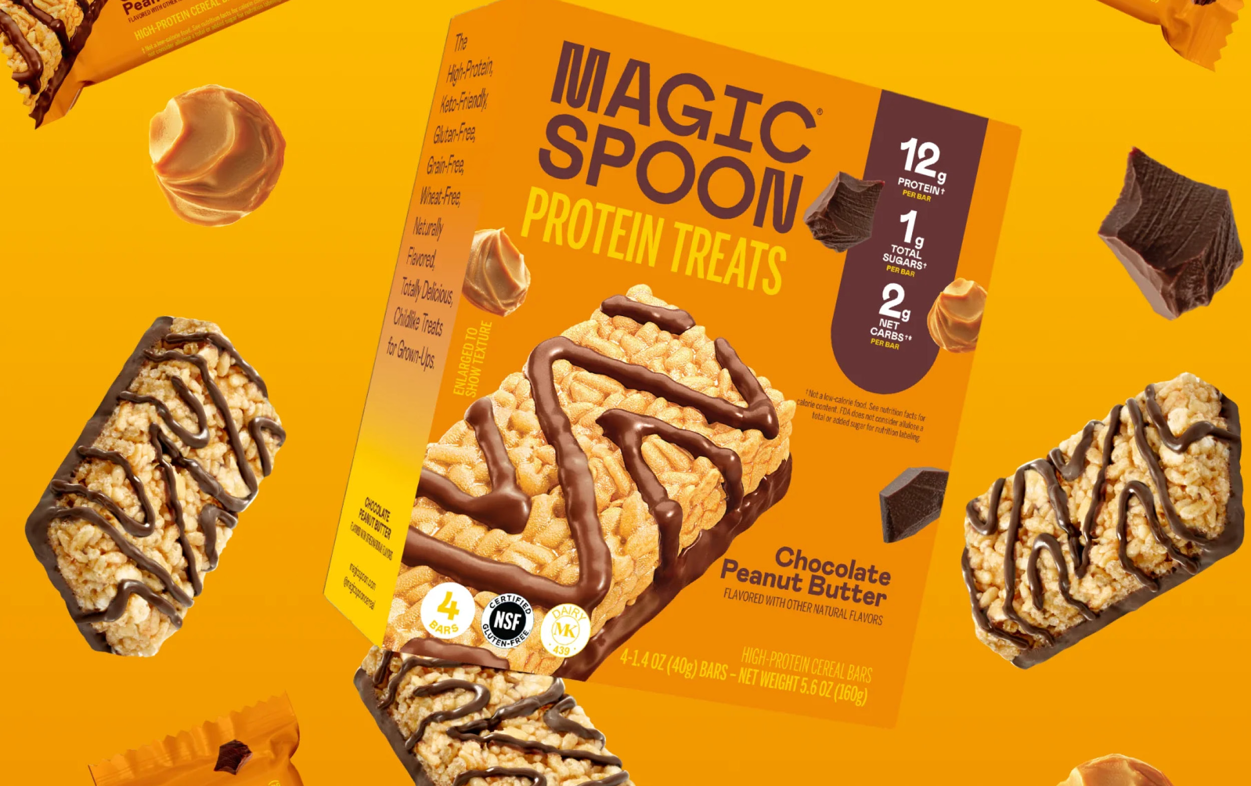 A box of Magic Spoon Protein Treats, Chocolate Peanut Butter flavor, is shown with treats and ingredients floating on an orange background. As part of our New Arrivals, the box highlights 12g protein and just 1g sugar.
