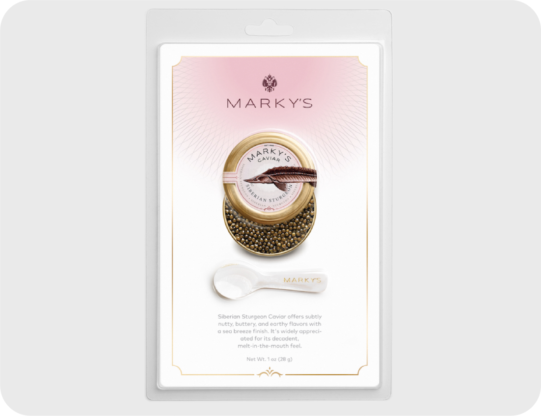 A package of Markys Siberian Sturgeon Caviar is displayed with a small white spoon, making it a highlight at any Seafood Showcase. The packaging features gold accents, a caviar tin, and a description of the caviar’s taste and texture.