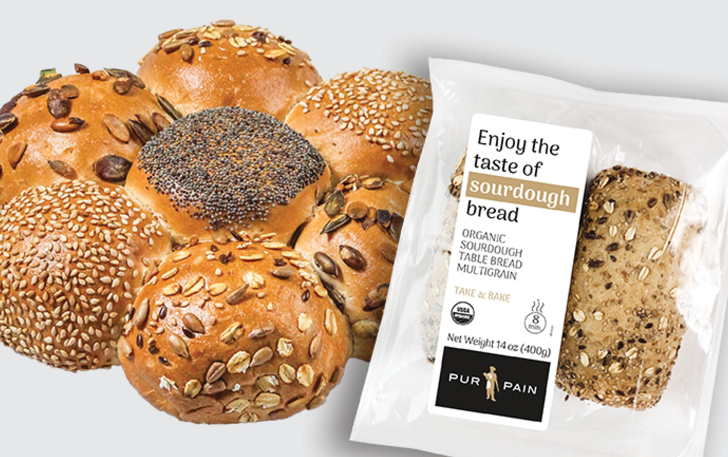 A round cluster of multigrain bread rolls with various seeds sits beside a clear package containing two seeded sourdough bread pieces labeled Enjoy the taste of sourdough bread.