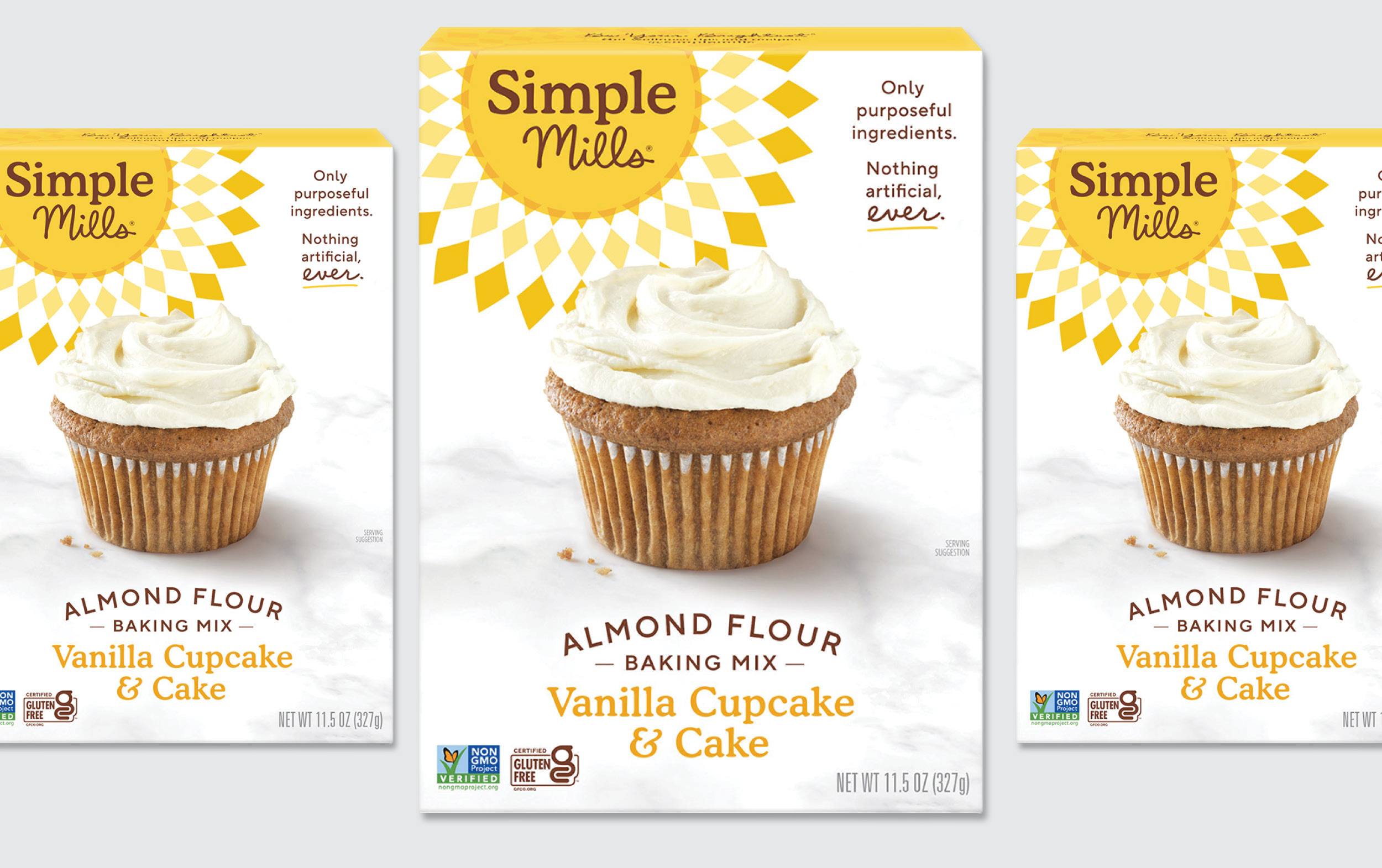 Three boxes of Simple Mills Almond Flour Baking Mix for Vanilla Cupcake & Cake, each featuring an image of a frosted cupcake on the front, with yellow and white checkered accents on the packaging.