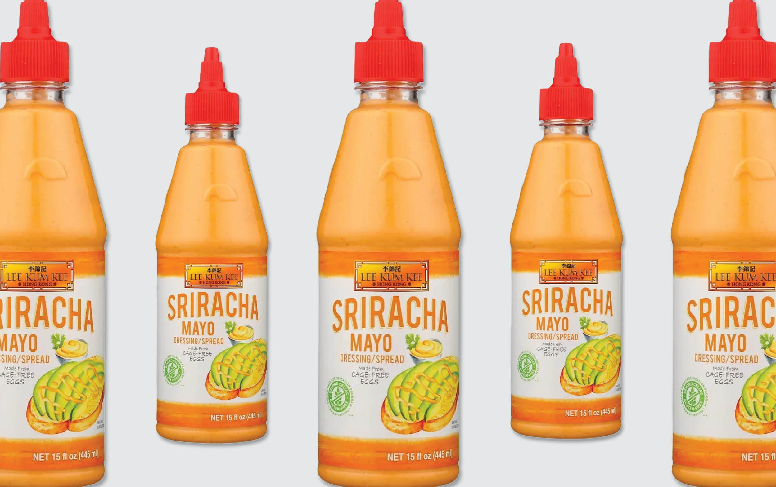 Five bottles of Lee Kum Kee Sriracha Mayo Dressing Spread, each with an orange label, green chili and yellow mayonnaise images, and a red cap, are lined up against a plain light background.